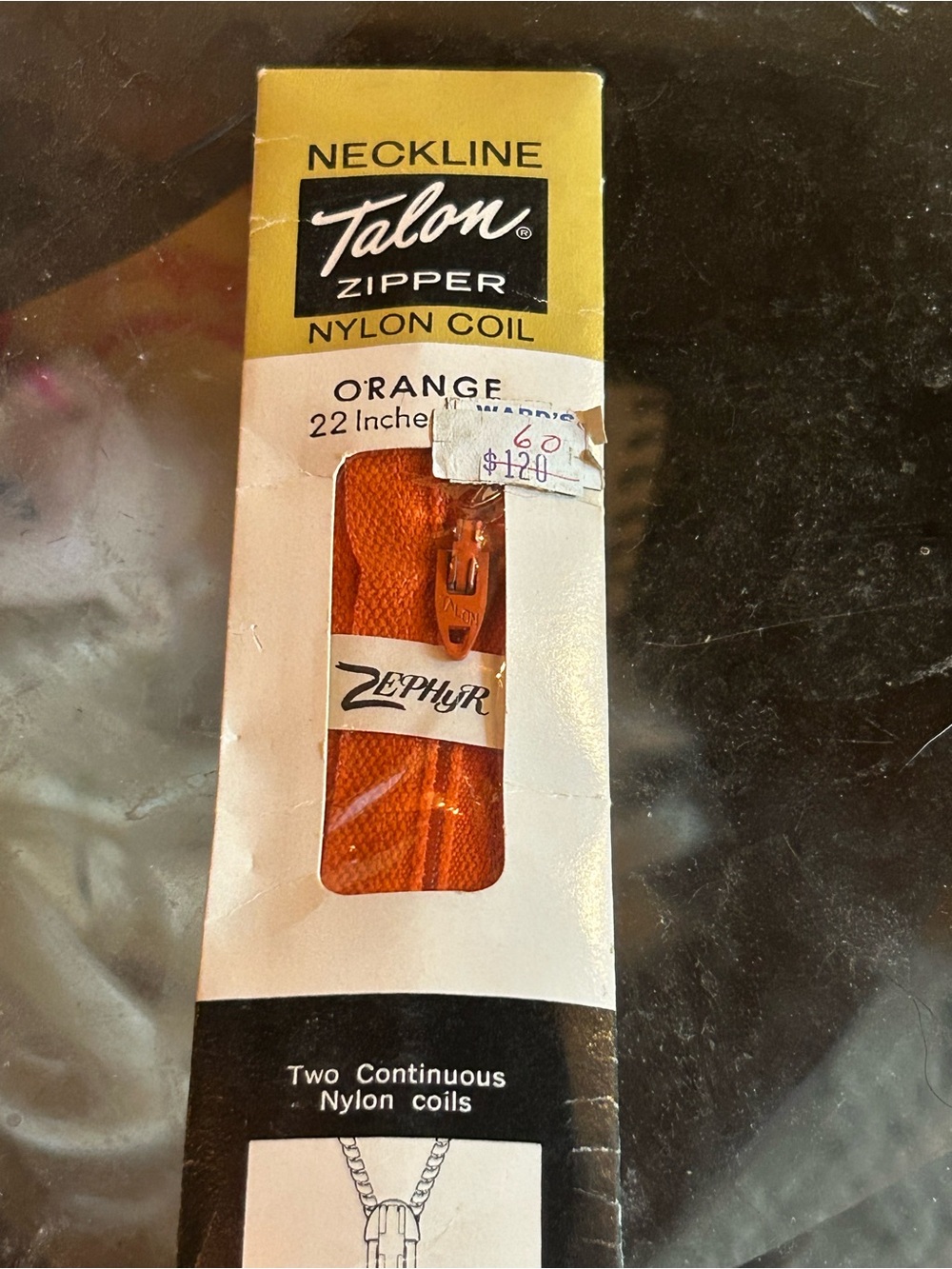 vintage 22-inch orange "Talon" brand nylon coil neckline zipper.